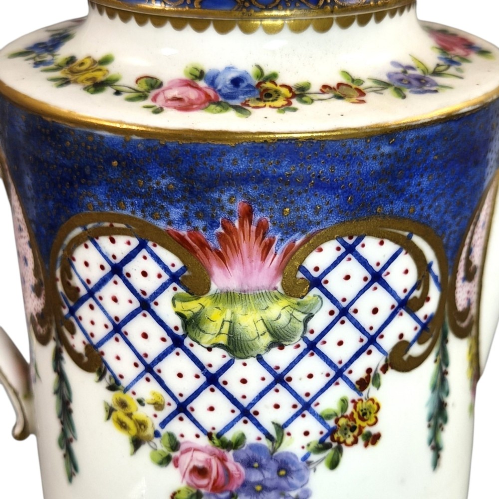 An 18th-century French Sevres soft-paste porcelain litron teapot decorated with hand-painted floral cartouches, gilding, and cobalt blue borders. View XI