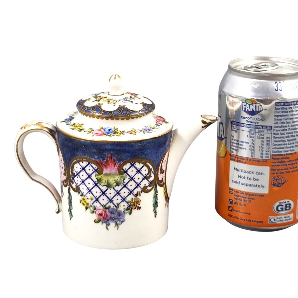 An 18th-century French Sevres soft-paste porcelain litron teapot decorated with hand-painted floral cartouches, gilding, and cobalt blue borders. View XII