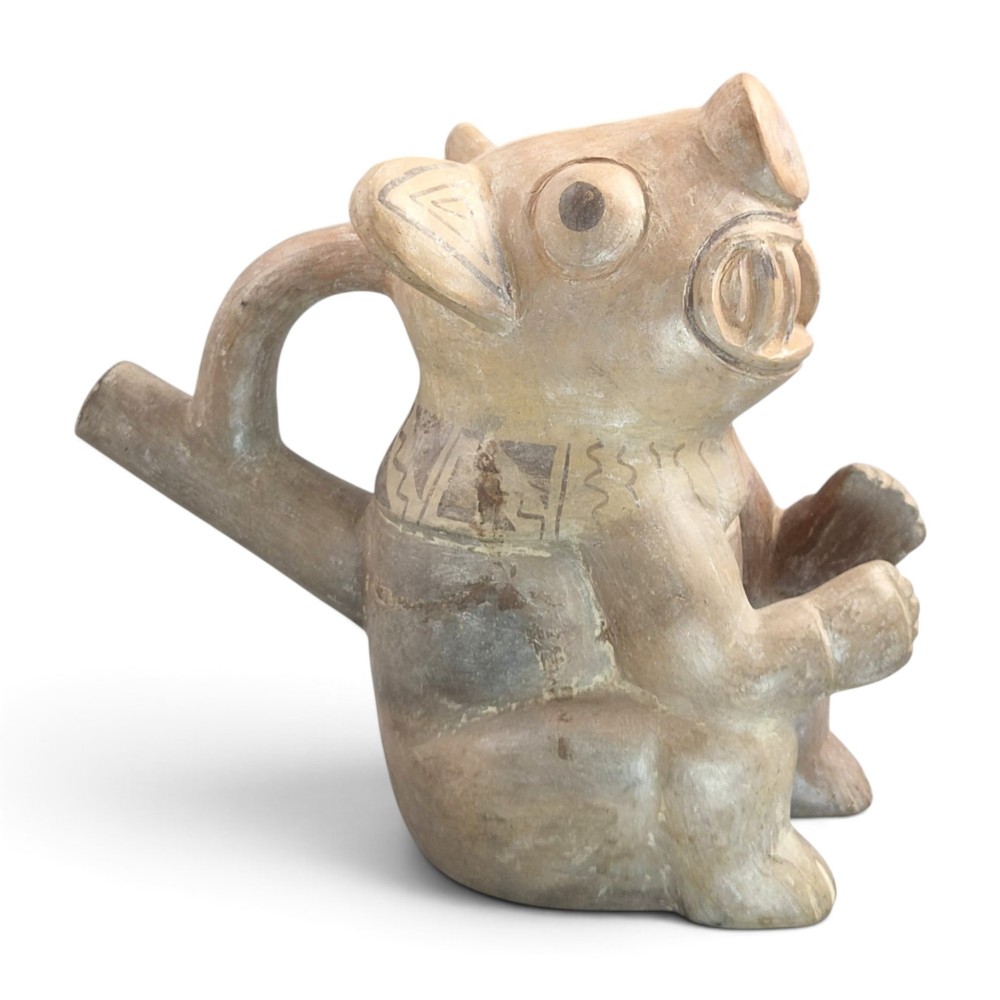 A pre-Columbian terracotta zoomorphic vessel featuring an animal form with painted geometric patterns around the neck and a integrated handle spout.