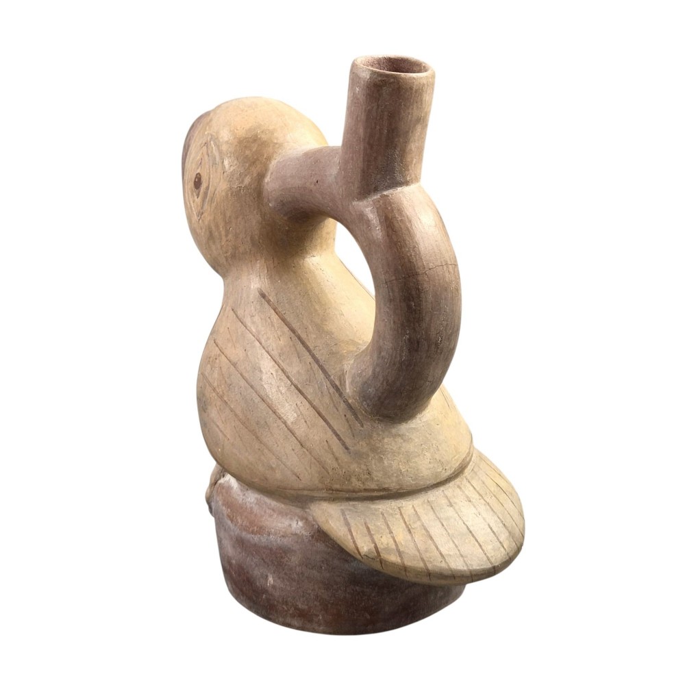 A beige terracotta Pre-Columbian stirrup spout vessel sculpted in the shape of a perched bird. View II
