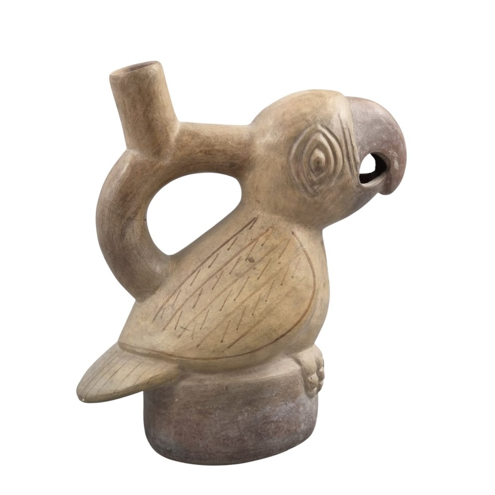 A beige terracotta Pre-Columbian stirrup spout vessel sculpted in the shape of a perched bird. View IV