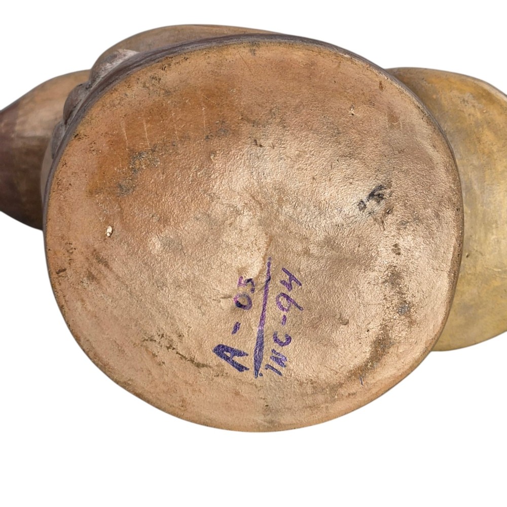 A beige terracotta Pre-Columbian stirrup spout vessel sculpted in the shape of a perched bird. View IX