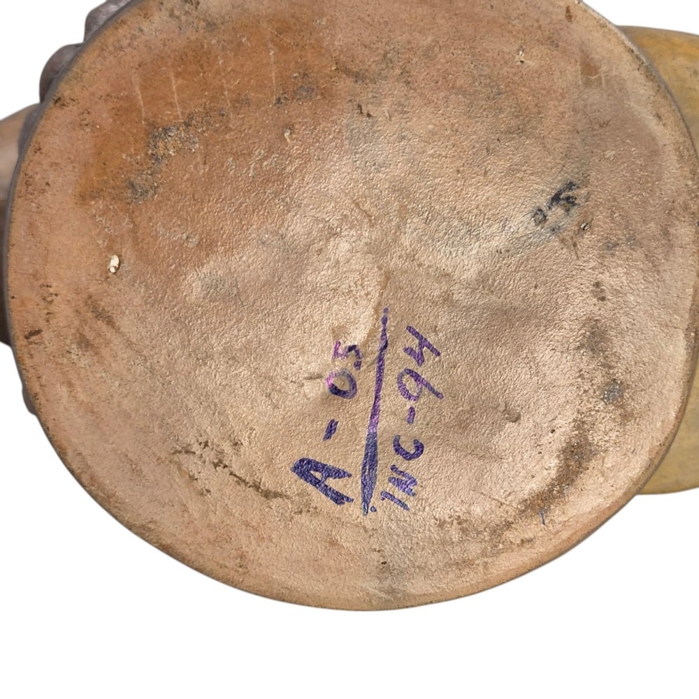 A beige terracotta Pre-Columbian stirrup spout vessel sculpted in the shape of a perched bird. View X