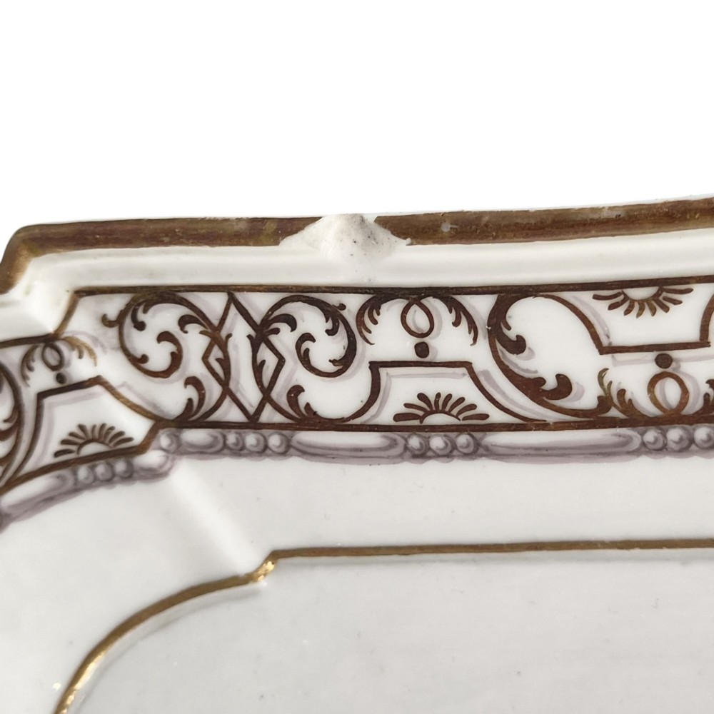 An eighteenth-century rectangular white porcelain serving tray featuring shaped corners, delicate gilded scrollwork borders, and a central hand-painted crowned monogram. View III