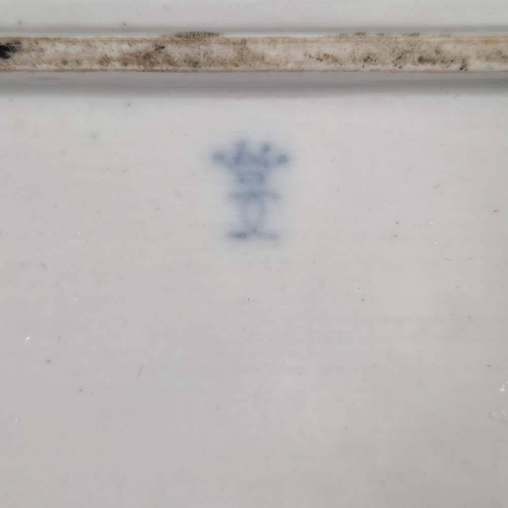 An eighteenth-century rectangular white porcelain serving tray featuring shaped corners, delicate gilded scrollwork borders, and a central hand-painted crowned monogram. View VI