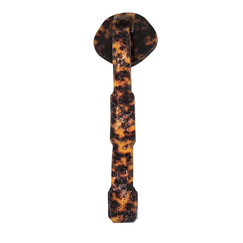 A late 19th-century Chinese Qing Dynasty ruyi sceptre carved from translucent mottled amber and dark brown tortoiseshell with intricate relief carving along the handle and head. View V