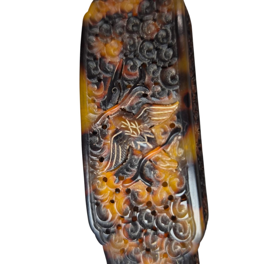 A late 19th-century Chinese Qing Dynasty ruyi sceptre carved from translucent mottled amber and dark brown tortoiseshell with intricate relief carving along the handle and head. View XIII