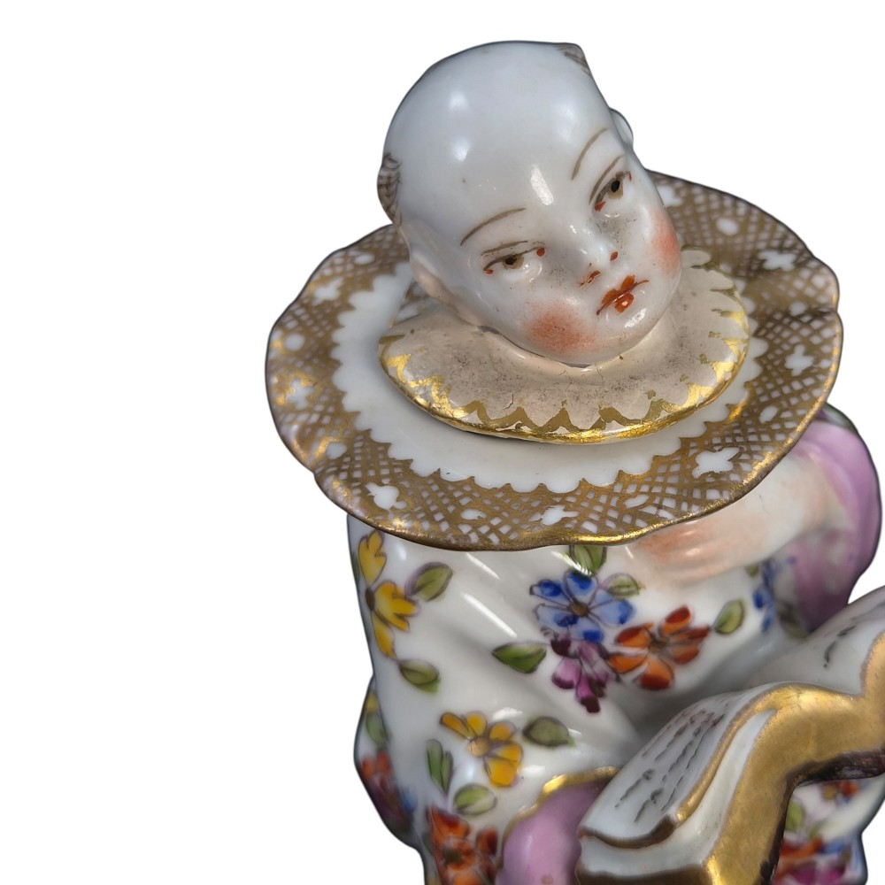 A pair of antique French Samson porcelain figural inkwells depicting singing boys wearing floral robes and gilt-rimmed ruffs while holding open songbooks. View XIII