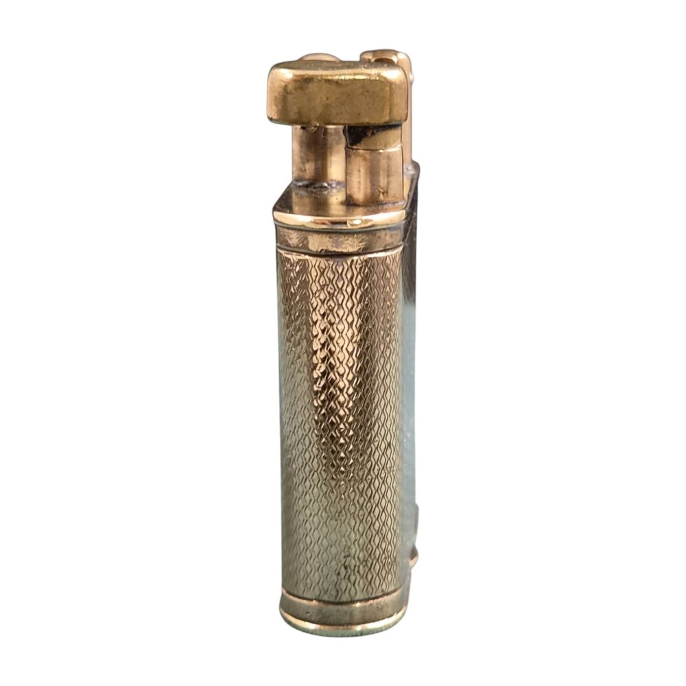 A 1920s Dunhill Unique gold-plated petrol lighter featuring an engine-turned pattern and a straight-arm lift mechanism. View IV