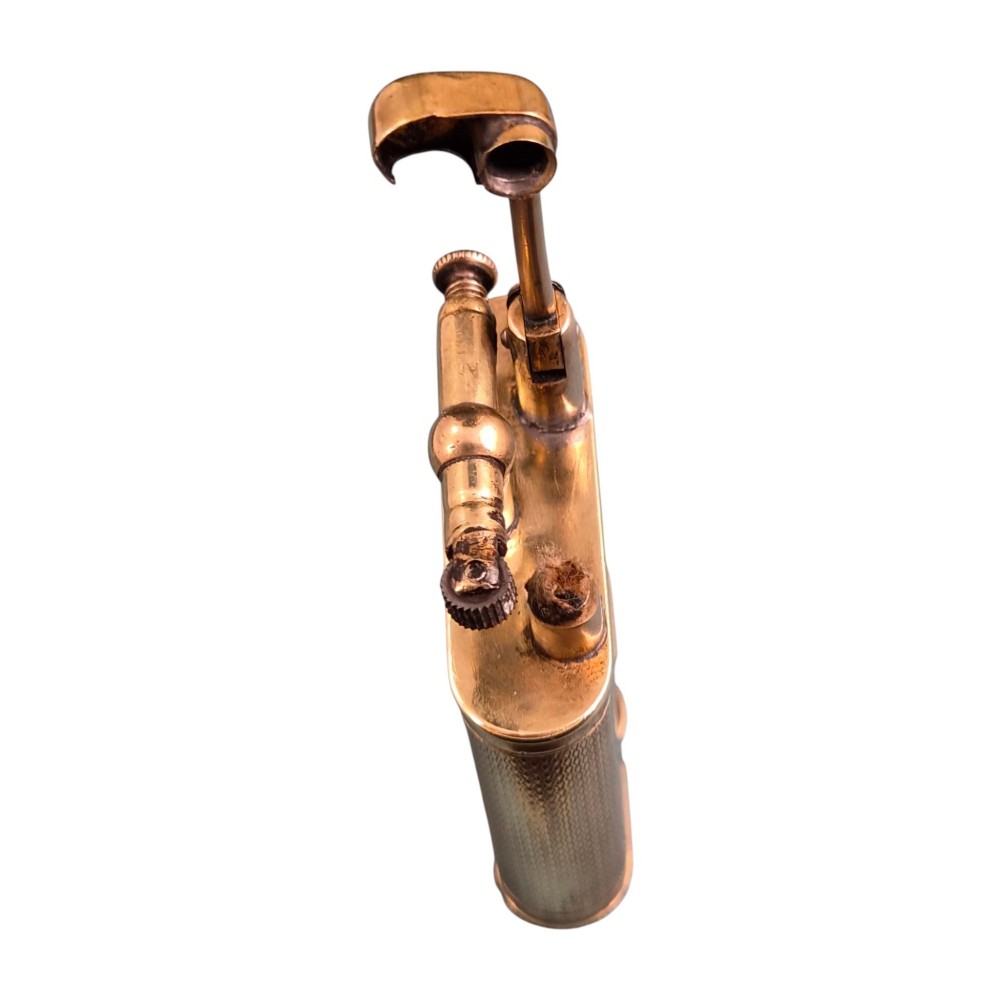 A 1920s Dunhill Unique gold-plated petrol lighter featuring an engine-turned pattern and a straight-arm lift mechanism. View VII