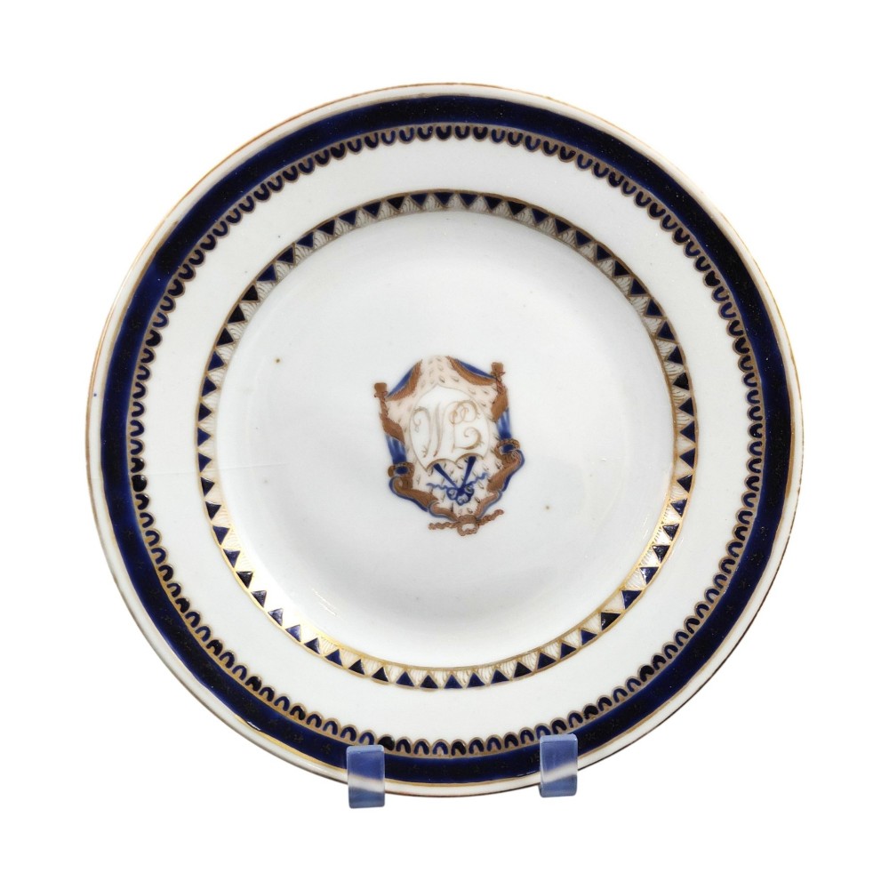A five-piece late 18th-century Chinese export porcelain tea service featuring two cream jugs, two saucers, and a footed dish decorated with cobalt blue borders, gilt detailing, and central monograms. View II