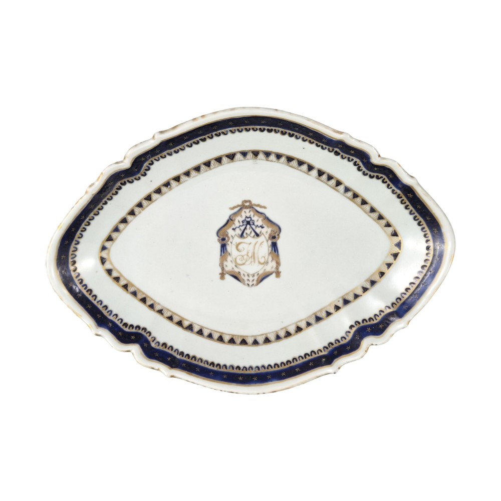 A five-piece late 18th-century Chinese export porcelain tea service featuring two cream jugs, two saucers, and a footed dish decorated with cobalt blue borders, gilt detailing, and central monograms. View VII