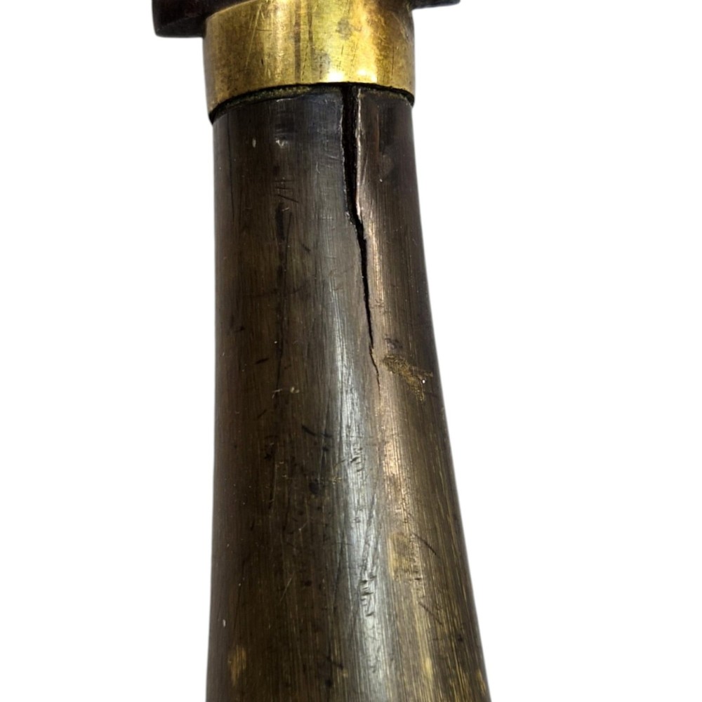 A 19th-century Pesh-Kabz knife featuring a recurved single-edged steel blade with surface etching, a brass bolster, and a tapered carved horn handle. View VI