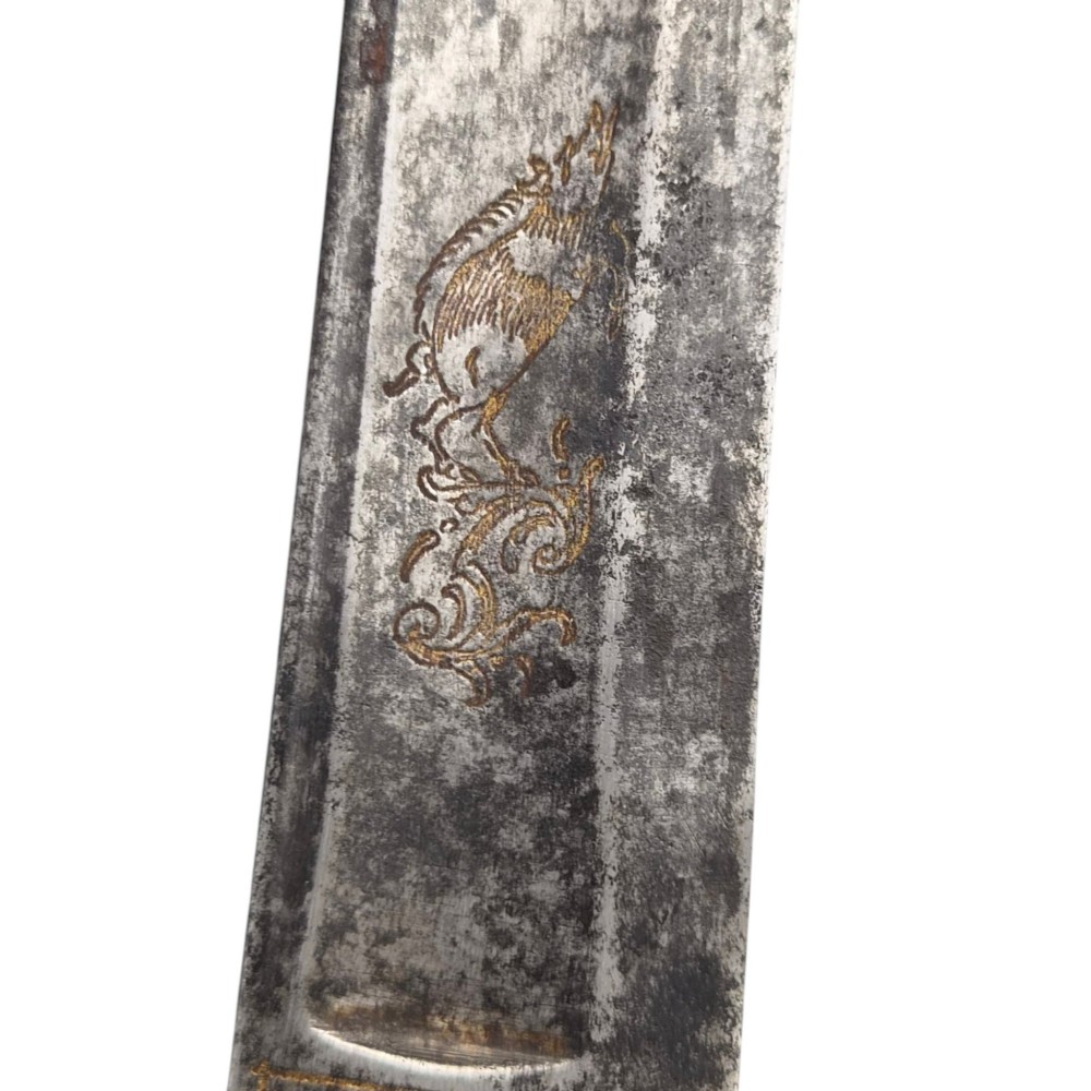 A 19th-century Pesh-Kabz knife featuring a recurved single-edged steel blade with surface etching, a brass bolster, and a tapered carved horn handle. View XII