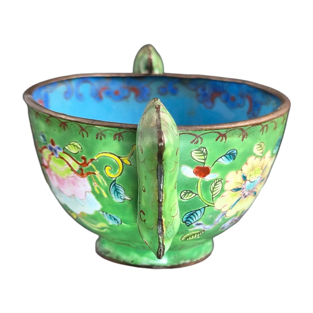 An eighteenth-century Chinese Canton enamel wine cup with green dragon-shaped handles resting on a matching round saucer, decorated with floral motifs and symbols. View III