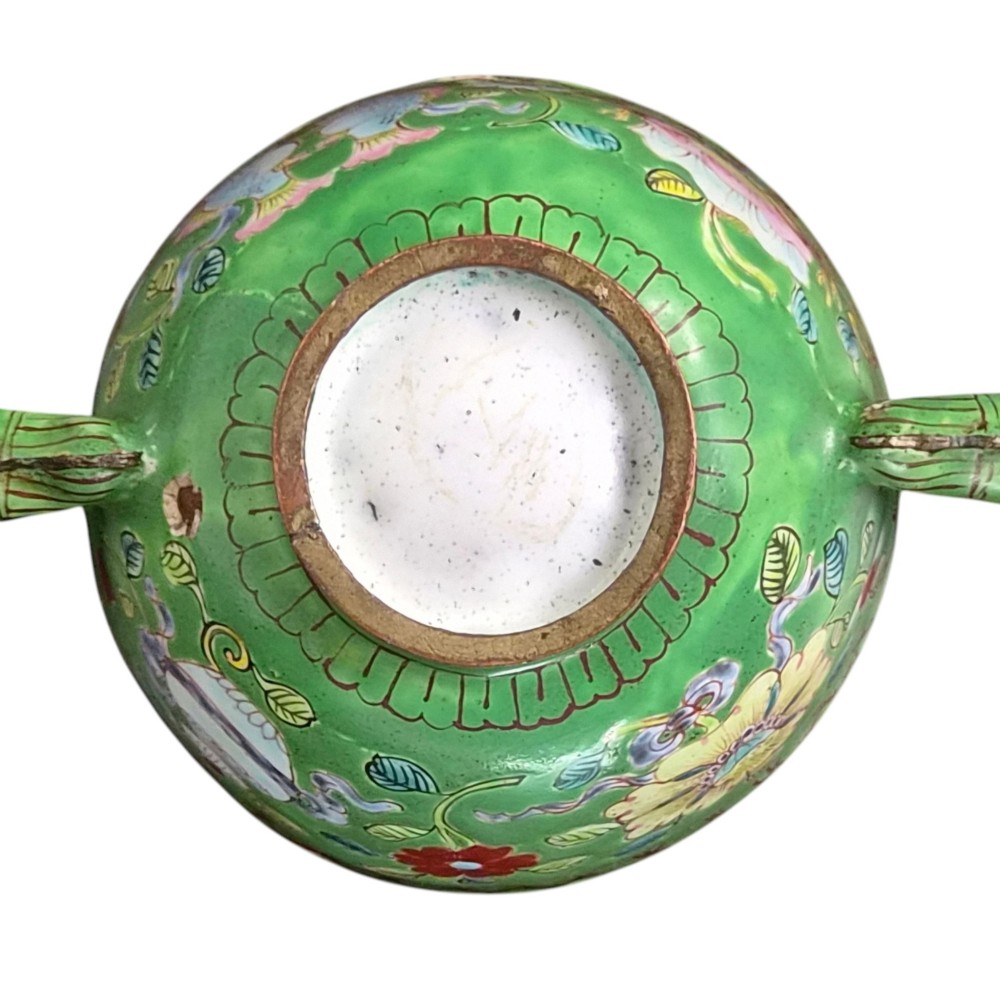 An eighteenth-century Chinese Canton enamel wine cup with green dragon-shaped handles resting on a matching round saucer, decorated with floral motifs and symbols. View IV