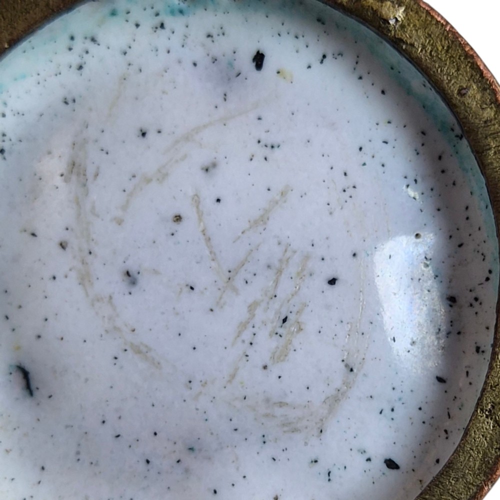 An eighteenth-century Chinese Canton enamel wine cup with green dragon-shaped handles resting on a matching round saucer, decorated with floral motifs and symbols. View VI