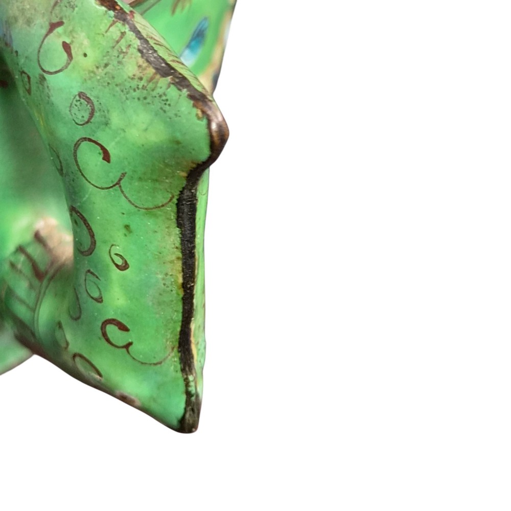 An eighteenth-century Chinese Canton enamel wine cup with green dragon-shaped handles resting on a matching round saucer, decorated with floral motifs and symbols. View VIII