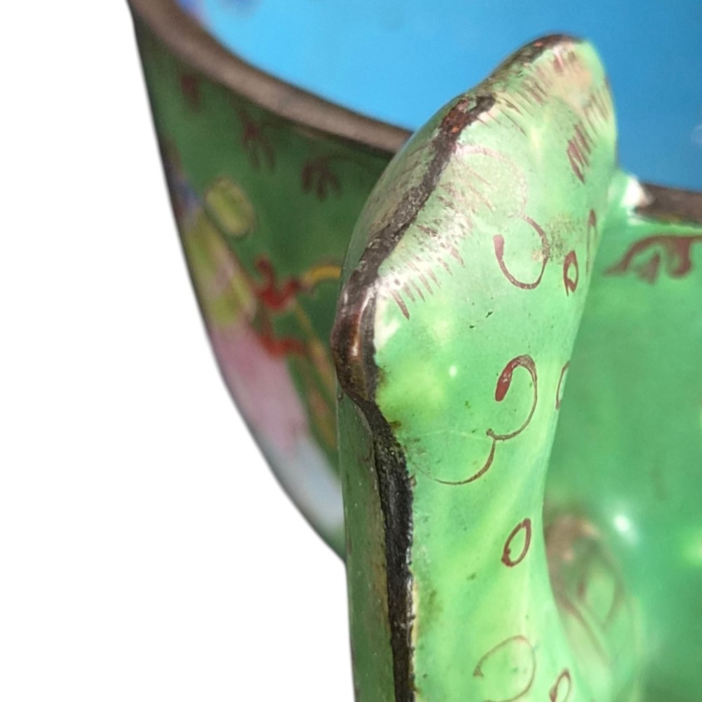 An eighteenth-century Chinese Canton enamel wine cup with green dragon-shaped handles resting on a matching round saucer, decorated with floral motifs and symbols. View XV
