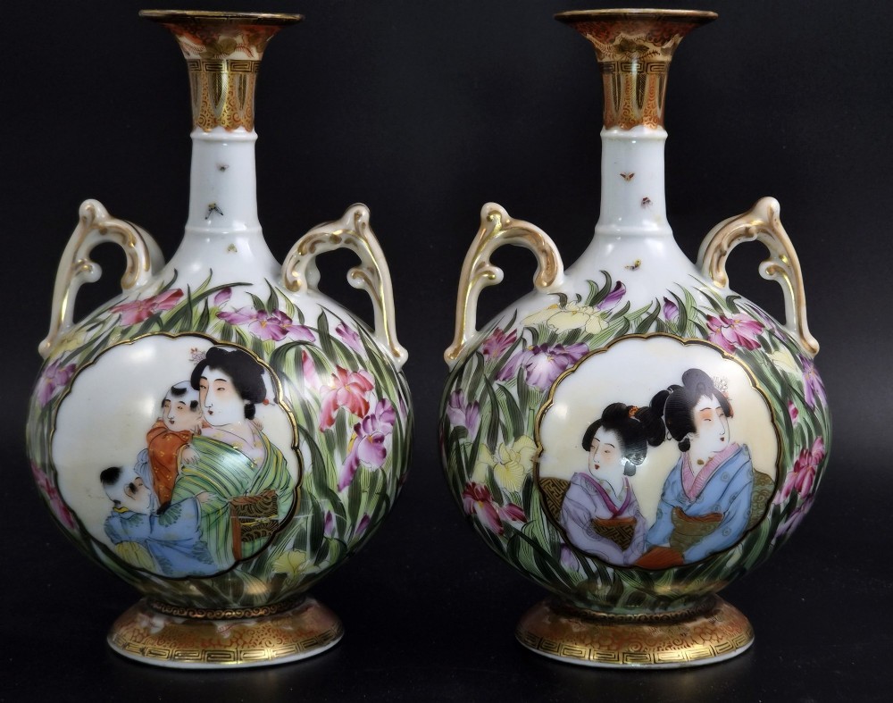A pair of Japanese Yokohama porcelain vases decorated with hand-painted figures, floral irises, twin gilt handles, and gilded neck details. View III