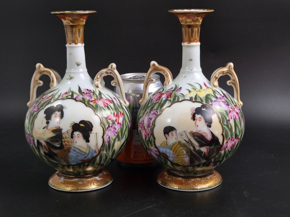 A pair of Japanese Yokohama porcelain vases decorated with hand-painted figures, floral irises, twin gilt handles, and gilded neck details. View XII