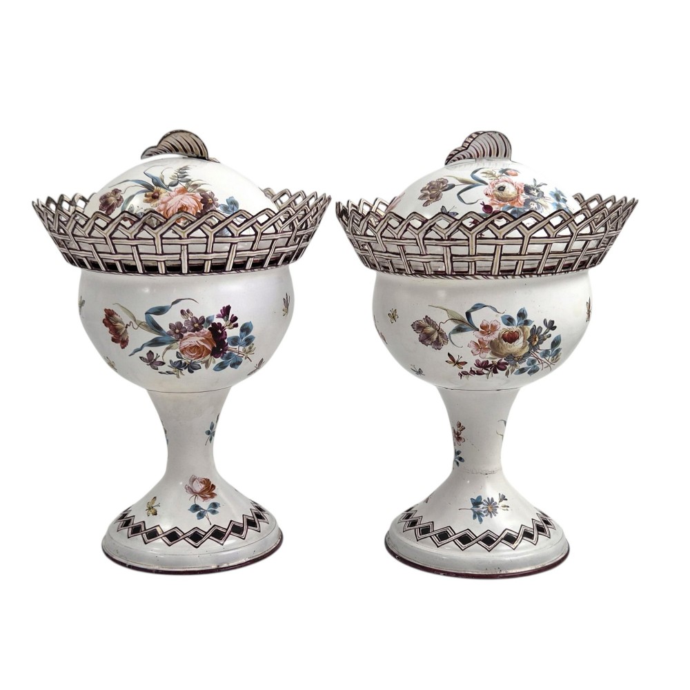 A pair of off-white 19th-century French tole peinte chestnut urns featuring hand-painted botanical motifs, pierced lattice galleries, and shell-form finials on the lids. View III