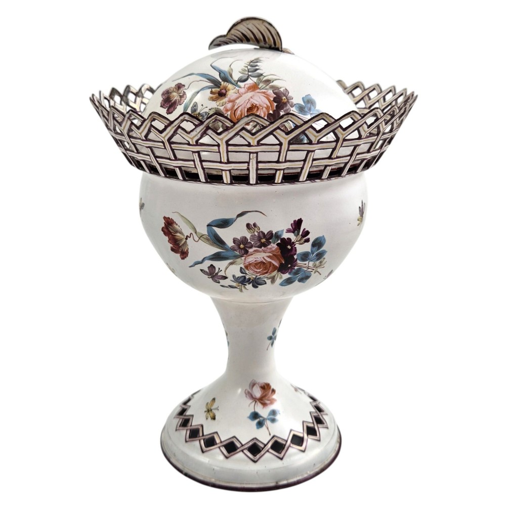 A pair of off-white 19th-century French tole peinte chestnut urns featuring hand-painted botanical motifs, pierced lattice galleries, and shell-form finials on the lids. View IV