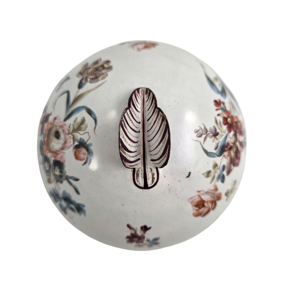 A pair of off-white 19th-century French tole peinte chestnut urns featuring hand-painted botanical motifs, pierced lattice galleries, and shell-form finials on the lids. View XI