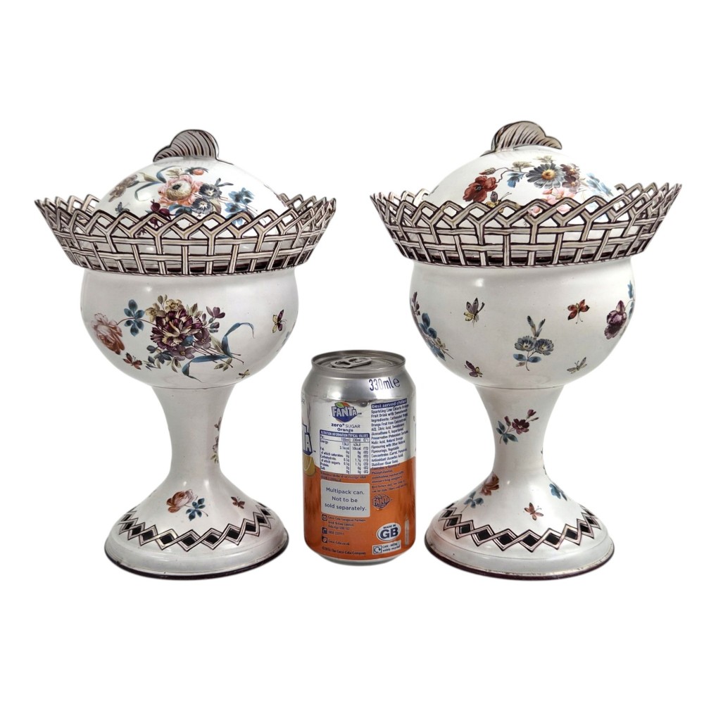 A pair of off-white 19th-century French tole peinte chestnut urns featuring hand-painted botanical motifs, pierced lattice galleries, and shell-form finials on the lids. View XIII