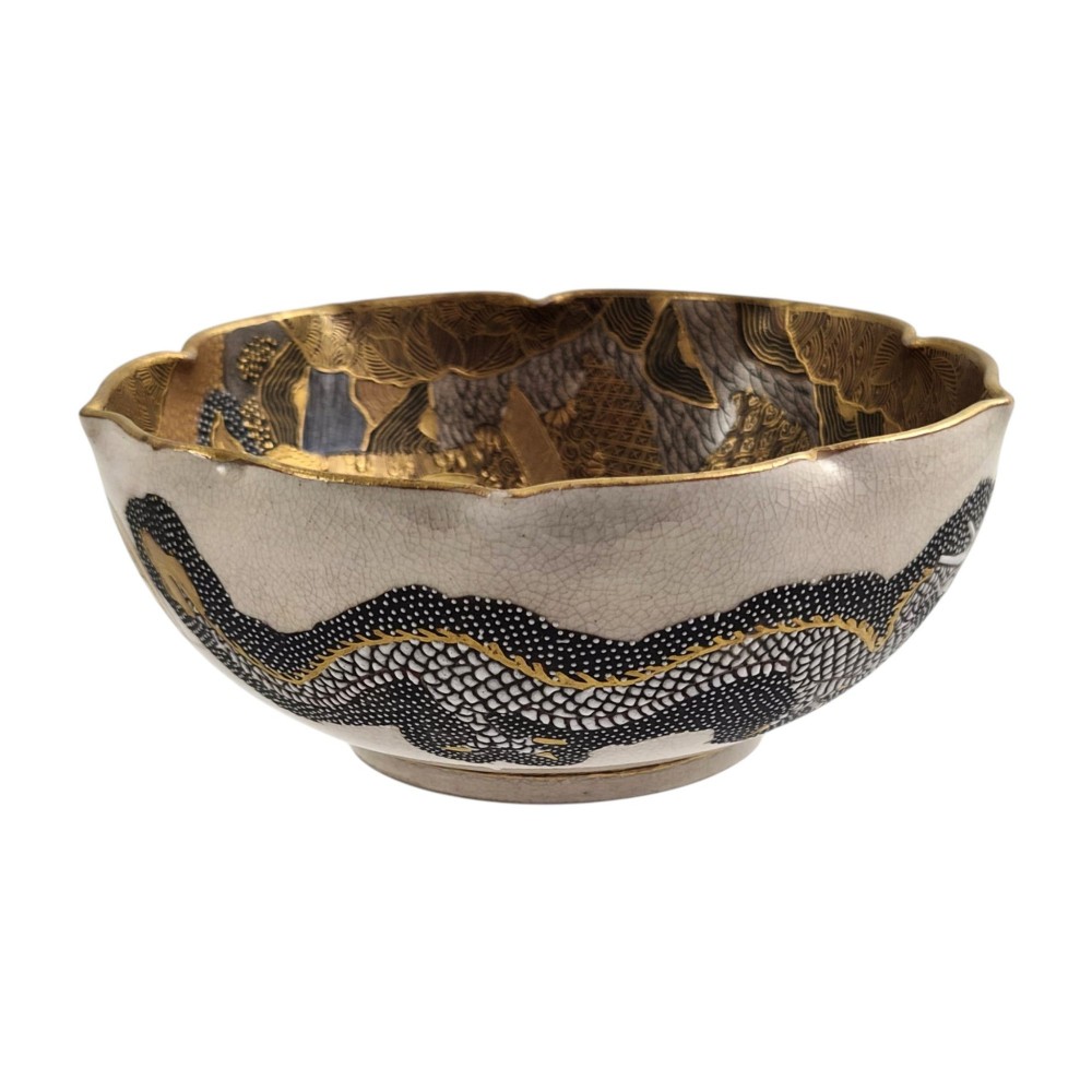 A lobed Japanese Satsuma earthenware bowl featuring detailed hand-painted figures of Rakan and a dragon accented with gold enamelling. View III