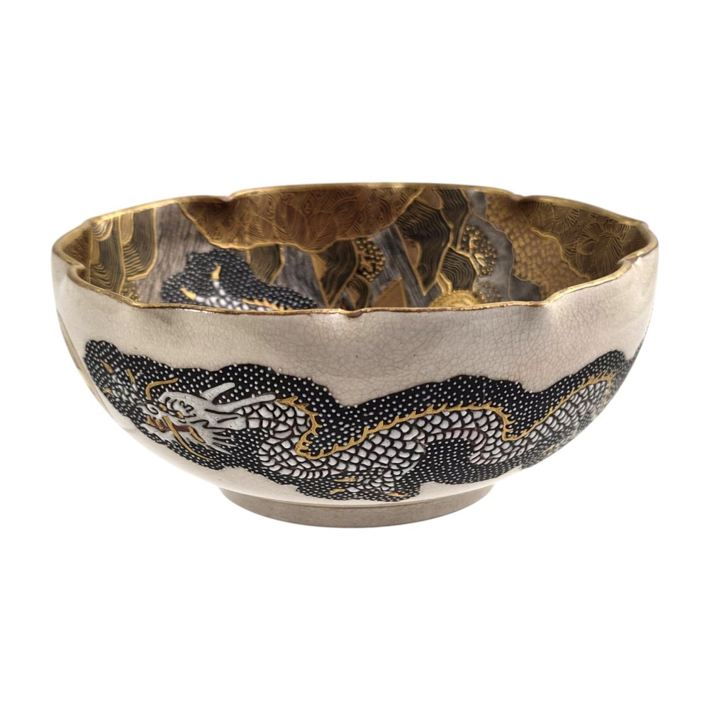 A lobed Japanese Satsuma earthenware bowl featuring detailed hand-painted figures of Rakan and a dragon accented with gold enamelling. View XIII