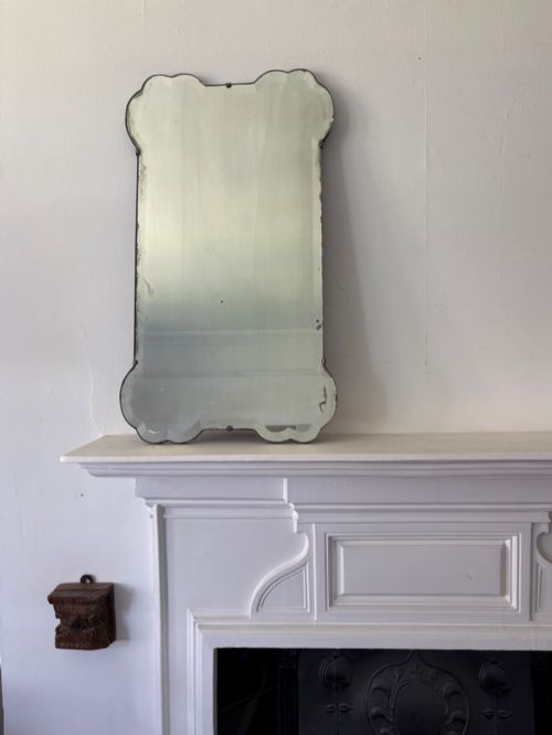 a shapely 1920s bevelled frameless art deco mirror 69cm tall gently foxed plate - CATEGORY: ANTIQUE MIRRORS - DATED 1920
