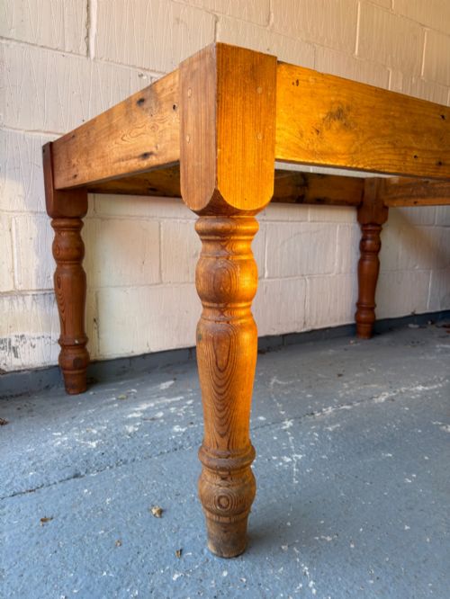 fig 2. An Edwardian rectangular pine farmhouse kitchen table featuring turned elm legs and a thick wooden top.
