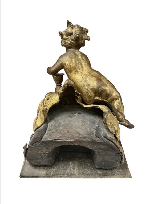 fig 1. A late eighteenth or nineteenth-century French gilt bronze ormolu sculpture featuring a reclining putto holding a small vessel above a scrolled arch base.