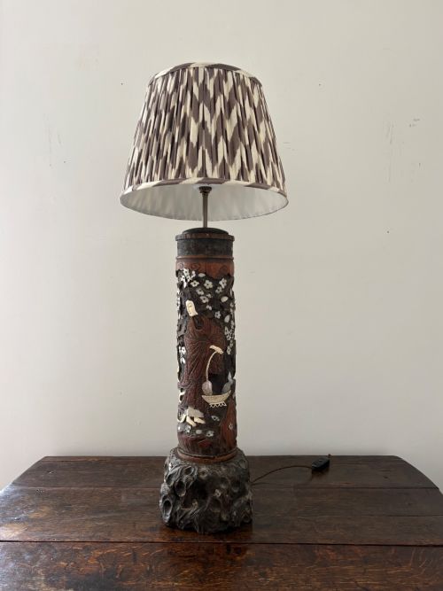 fig 1. A tall Japanese Meiji period carved wooden brush pot converted into a table lamp with mother-of-pearl details and a patterned pleated lampshade.
