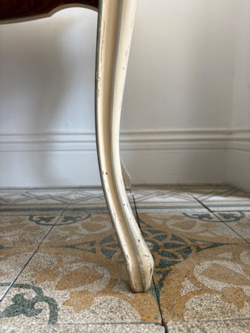 fig 2. A cream painted French console table featuring long cabriole legs, a shaped apron with subtle trim, and an inset suede tabletop.