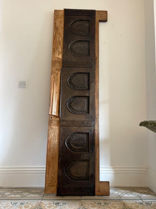 fig 1. A tall nineteenth-century dark oak architectural panel featuring six vertically arranged carved gothic arches with fan motifs.