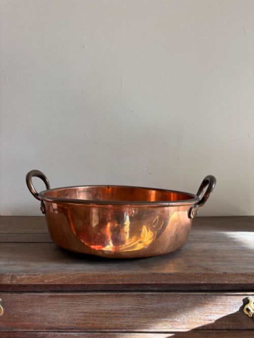 fig 1. A large 19th-century polished copper preserve pan featuring twin riveted brass handles.