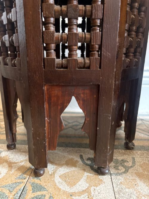 fig 3. A pair of dark wood octagonal stools with turned latticework side panels, arch-cut bases, and geometric woven kilim seat cushions.