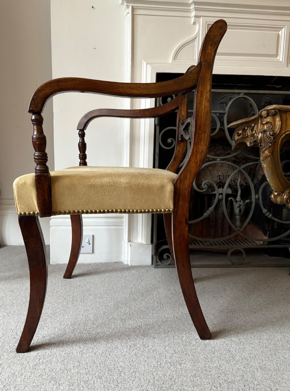 A Regency Mahogany Open Armchair with Studded Suede Seat and Sabre Legs, C1820