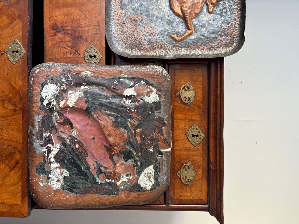 A pair of square late 19th-century hammered metal trays with raised repousse animal figures of an ibex and a feline. View VI