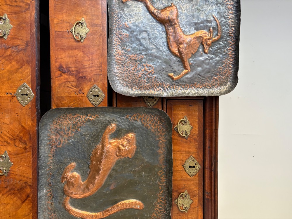 A pair of square late 19th-century hammered metal trays with raised repousse animal figures of an ibex and a feline. View VIII
