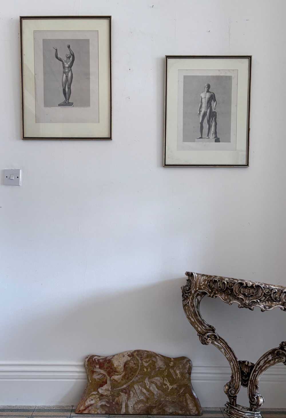 A pair of framed monochrome 19th-century classical engravings depicting ancient male sculptures mounted in cream mats. View III