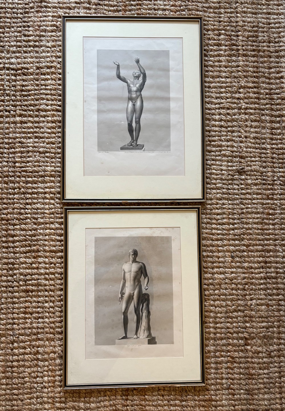 A pair of framed monochrome 19th-century classical engravings depicting ancient male sculptures mounted in cream mats. View IX