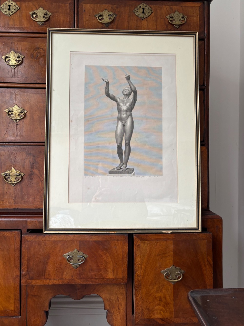A pair of framed monochrome 19th-century classical engravings depicting ancient male sculptures mounted in cream mats. View XI