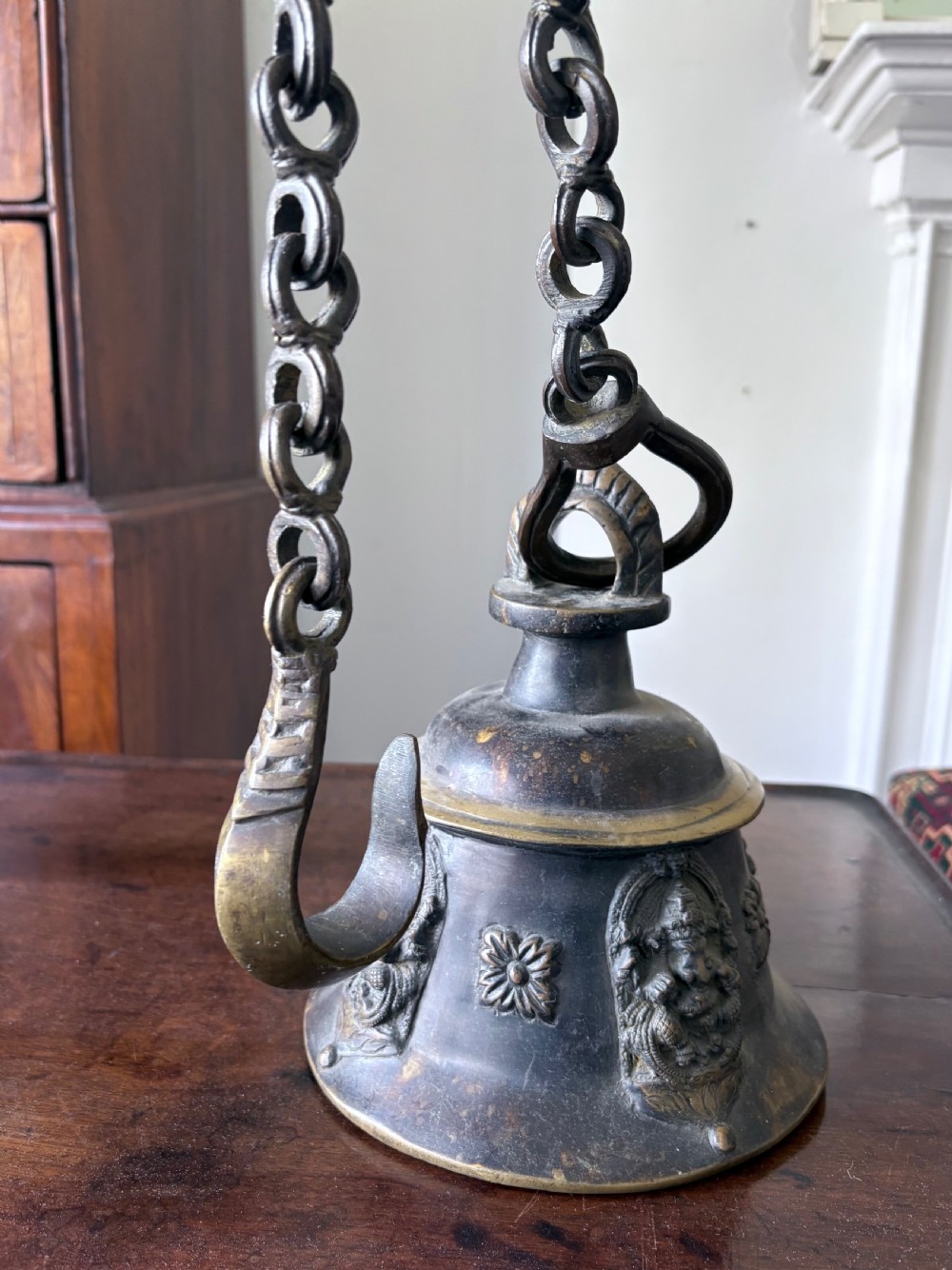 A Heavily Cast Bronze 19th Century Hindu Temple Bell and Chain, 108cm drop