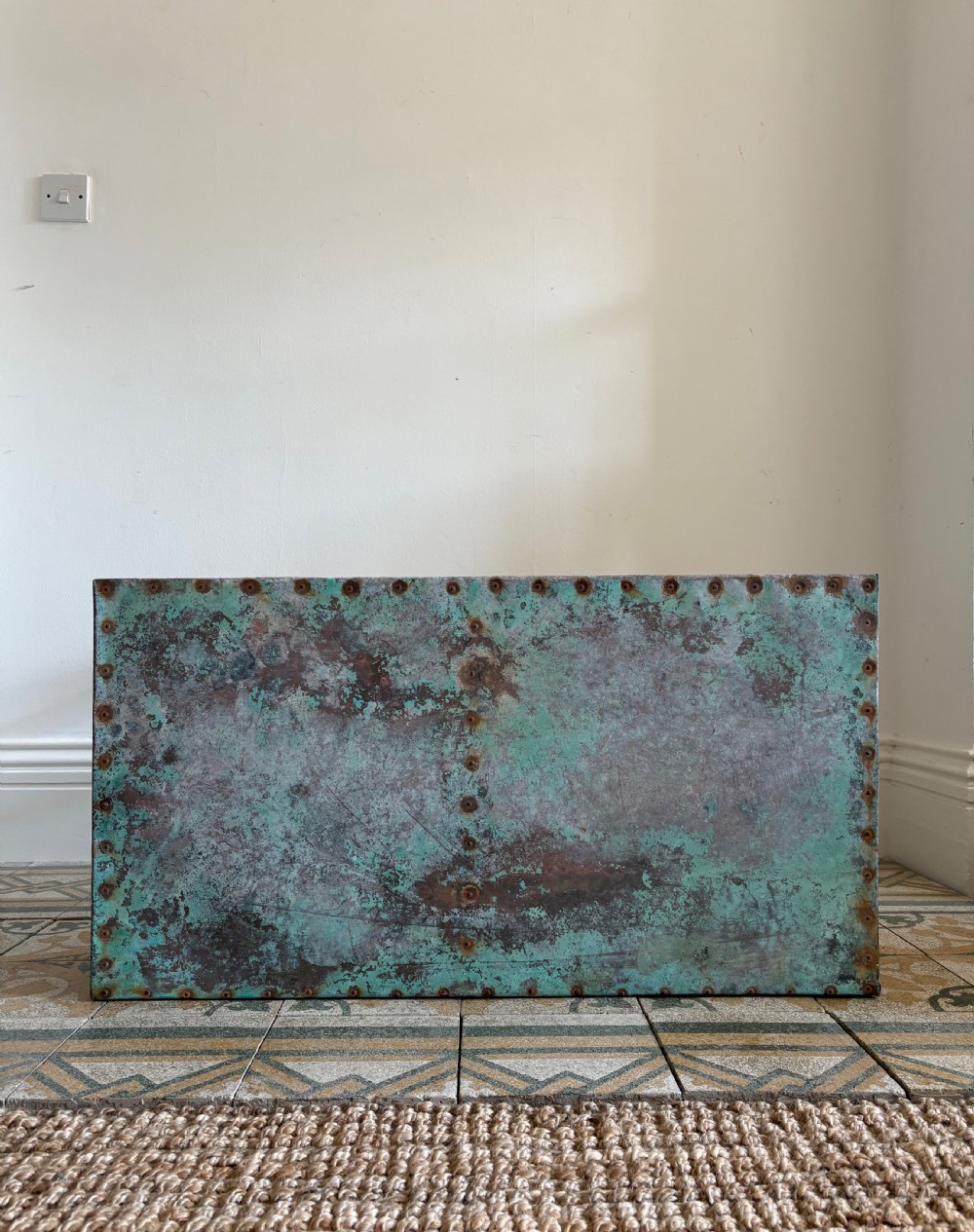 A French circa 1900 rustic wooden table with tapered legs and a verdigris copper sheet top edged with metal tacks. View II