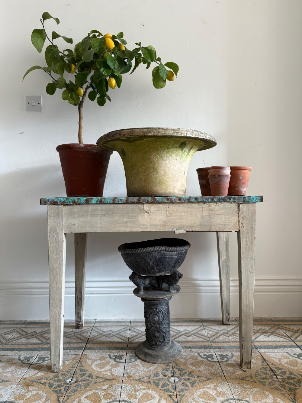 A French circa 1900 rustic wooden table with tapered legs and a verdigris copper sheet top edged with metal tacks. View IX