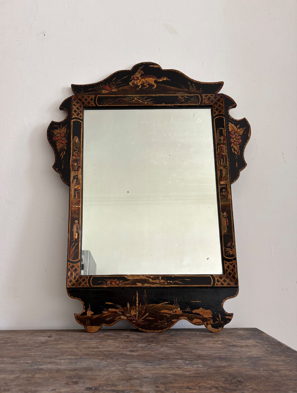 A 1920s Black Lacquer Chinoiserie Fret Cut Wall Mirror 72cm tall