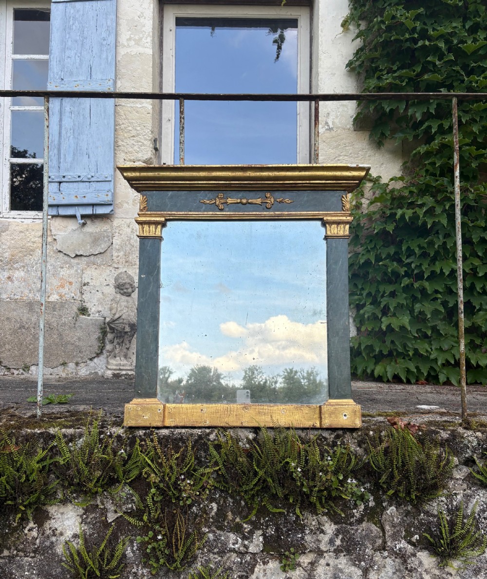 An early 19th-century Neoclassical rectangular wall mirror featuring a giltwood cornice and base flanking green faux-marble painted pilasters and frieze. View V